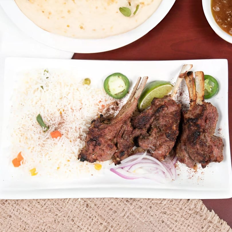 Mehran Restaurant's Pakistani lamb chops with rice, lime, jalapeños, and red onions.